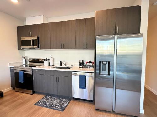 a kitchen with a stainless steel refrigerator at Nimitz Crossing Luxury Residences in San Diego