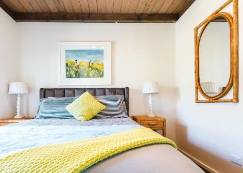 a bedroom with a bed and a mirror at Blue Pearl Retreat - Opp Beach, Spa, Sunsets and Pool in Mornington