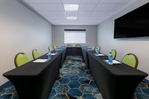 a conference room with long tables and chairs at Holiday Inn Express Spokane-Valley by IHG in Spokane Valley