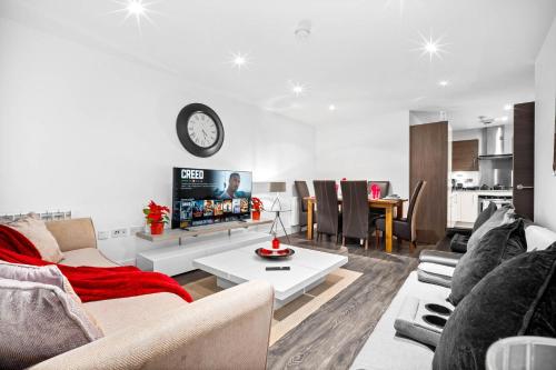 a living room with a couch and a table at Luxury City Centre 3Bedroom 5Beds Apartment with Allocated Parking in Birmingham