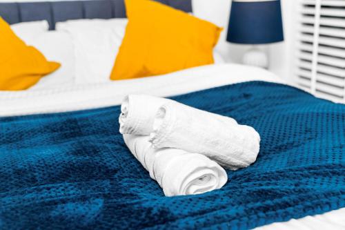 a roll of toilet paper sitting on a bed at Luxury City Centre 3Bedroom 5Beds Apartment with Allocated Parking in Birmingham