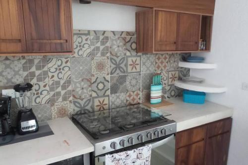 a kitchen with a stove top oven in a kitchen at Manzanillo Ocean Views Las Hadas Peninsula in Manzanillo