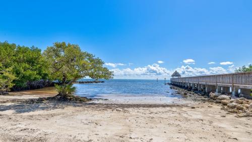 a beach with a pier next to the water at Reel Key Largo Escape Ocean Pointe 5209 in Key Largo