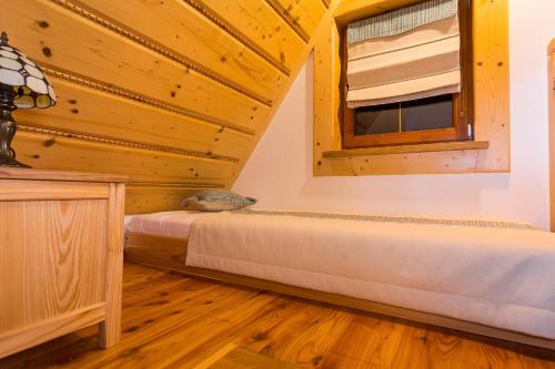 a bedroom with two beds and a window at Rezydencja Na Szymoszkowej in Zakopane