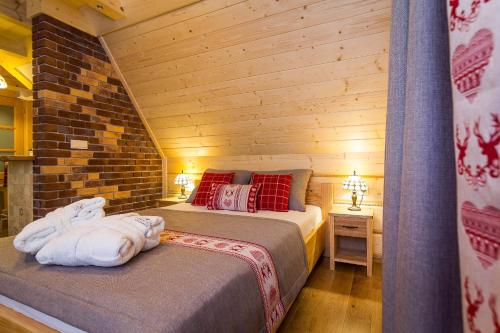 a bedroom with two beds in a log cabin at Rezydencja Na Szymoszkowej in Zakopane