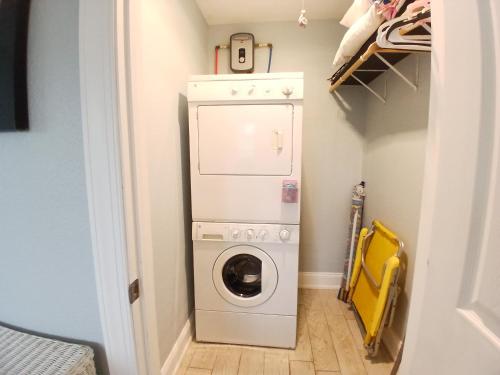 a laundry room with a washer and dryer at Sand Dollar Updated Kitchen Washer Dryer On River 1 Mile to Beach Sleeps 4 in Bonita Springs
