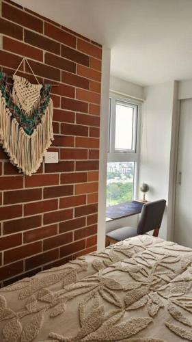 a bedroom with a brick wall and a bed at Wanderer estilo boho chic in Las Victorias