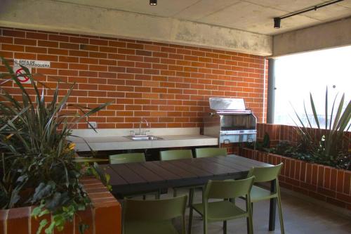 a kitchen with a table and chairs and a brick wall at Wanderer estilo boho chic in Las Victorias