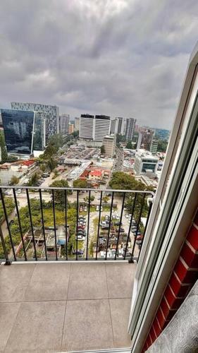 a balcony with a view of a city with cars at Wanderer estilo boho chic in Las Victorias