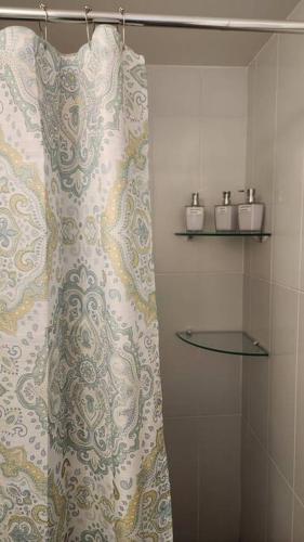 a shower curtain in a bathroom with two candles at Wanderer estilo boho chic in Las Victorias