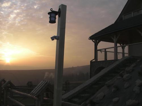 a street light with a sunset in the background at Willa Grywałd in Grywałd