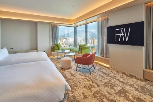 a hotel room with a bed and a large window at FAV LUX Kagoshima Tenmonkan in Kagoshima