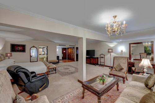 a large room with a bed and a living room at Karachi Marriott Hotel in Karachi