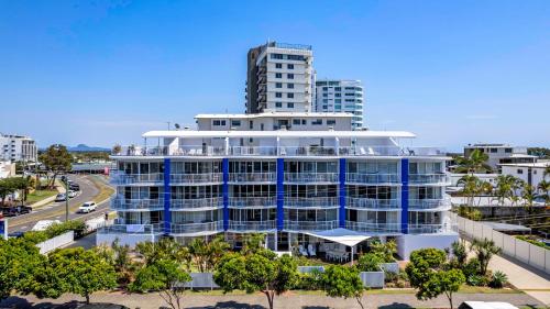 an aerial view of a blue building with a tall building at Coral Sea Apartments in Maroochydore