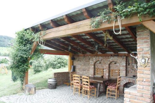 a patio with a table and chairs under a pavilion at U Zvoničky in Velké Losiny