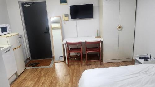 a small room with a table and two chairs at Kiman09 in Seoul
