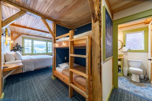 a bedroom with a bunk bed and a bathroom at Downtown Camden Hotel in Camden