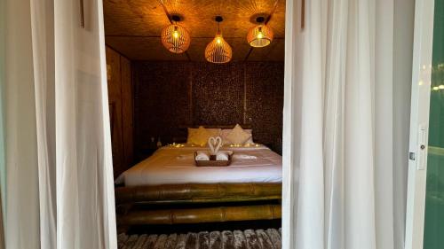 a bedroom with a bed with two rabbits in a basket at Greenheart garden View Camp phuket in Kata Beach