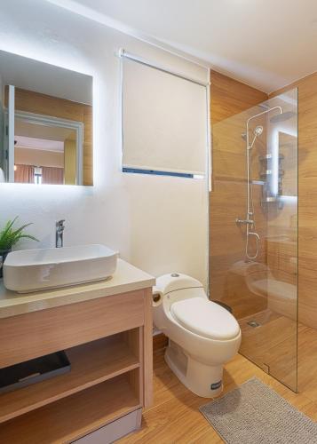 a bathroom with a toilet and a sink and a shower at Vista Cana Rooftop Picuzzy Apartment in Punta Cana