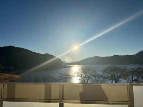 a view of a sunset from a balcony at Ashiwada Hotel in Fujikawaguchiko