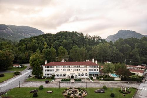 an aerial view of a building with mountains in the background at Lake Lure Inn and Spa in Lake Lure