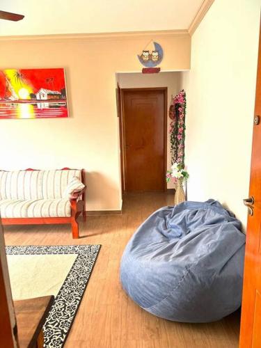 a living room with a bean bag chair and a couch at Apartamento no Guarujá - Enseada in Guarujá