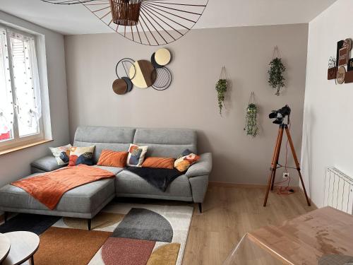 a living room with a couch and a tripod at Plage et Port à 2 Pas in Fécamp