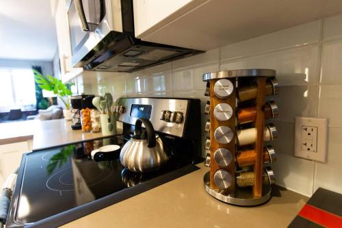 a kitchen with a stove with a tea kettle on it at 3 Miles to Disney Heated Pool CnvntnCtr Jacuzzi in Fullerton
