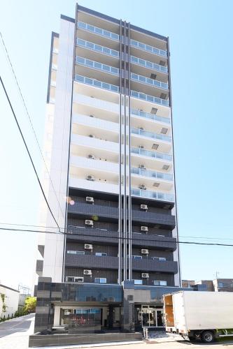 a tall building with a truck in front of it at Baycourt Otaru in Kita-hamachō