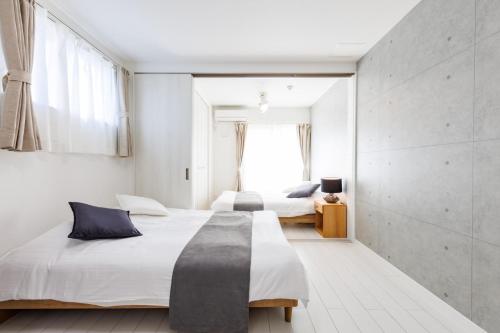 En eller flere senge i et værelse på しっぽタウンホテル岸里駅