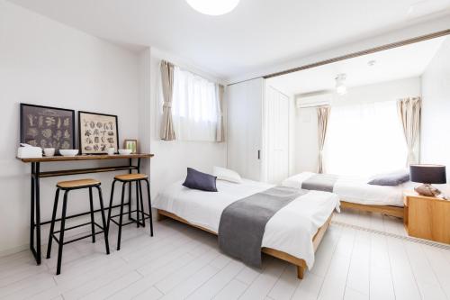 En eller flere senge i et værelse på しっぽタウンホテル岸里駅