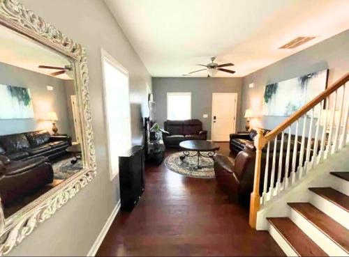 a living room with a mirror and a couch at Beautiful home near Carowinds, Ballantyne in Fort Mill
