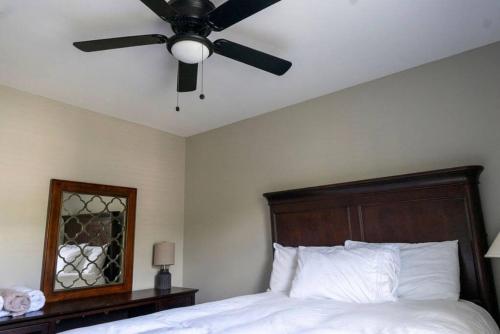 a bedroom with a ceiling fan and a bed at Beautiful home near Carowinds, Ballantyne in Fort Mill