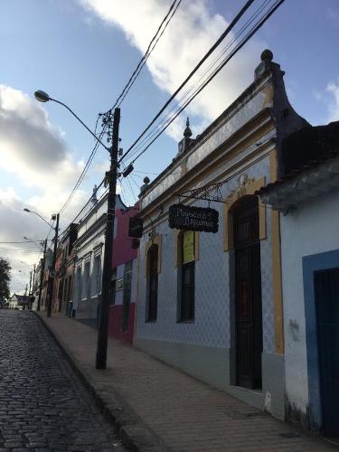 a street with a building on the side of a road at Pousada Alquimia in Olinda