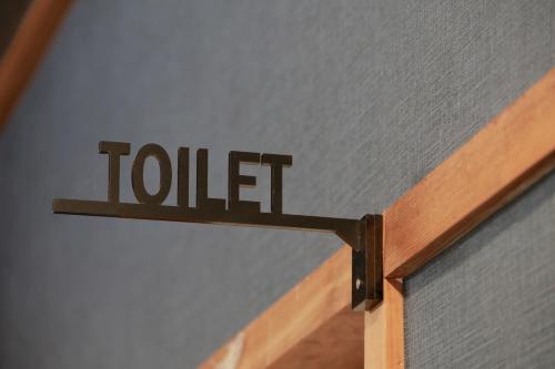 a sign that says toilet on a wall at 料理旅館ゆり野 in Wajiki