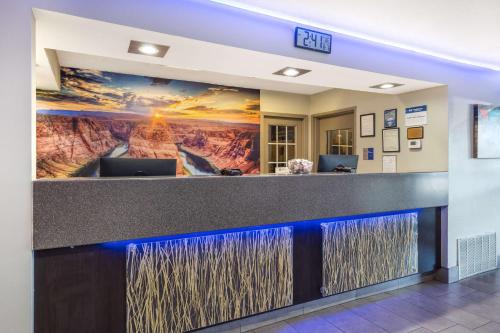an office lobby with a painting of a mountain at Best Western McCarran Inn in Las Vegas