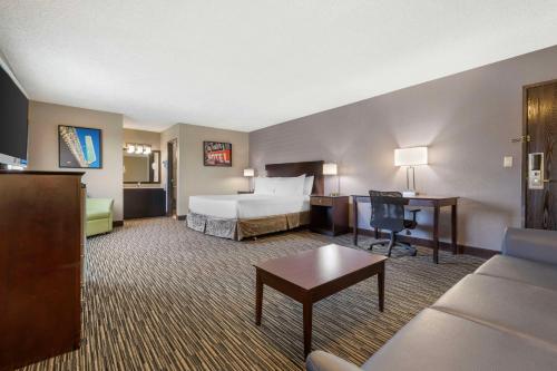a hotel room with a bed and a desk at Best Western McCarran Inn in Las Vegas