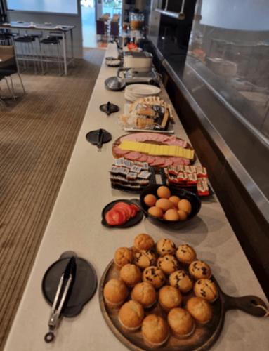 a long buffet line of food in a restaurant at Toowoomba Central Plaza Apartment Hotel Official in Toowoomba