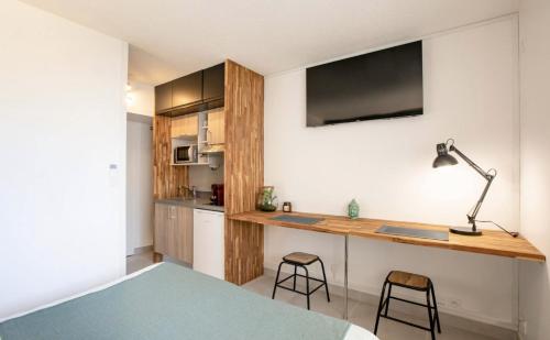 une chambre avec un lit et un bureau avec deux tabourets dans l'établissement Eden Room, à Saint-Tropez