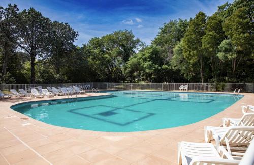 - une piscine avec des chaises et un bouquet d'équipements dans l'établissement Eden Room, à Saint-Tropez