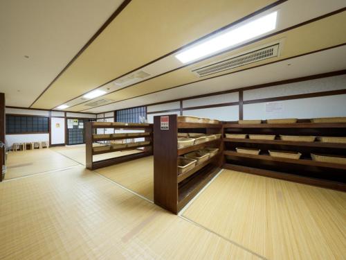 a bowling alley with wooden bowling racks in a room at Shuzenji Onsen Hotel Takitei in Izu
