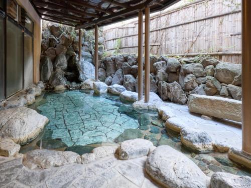 a pool of water with rocks around it at Shuzenji Onsen Hotel Takitei in Izu