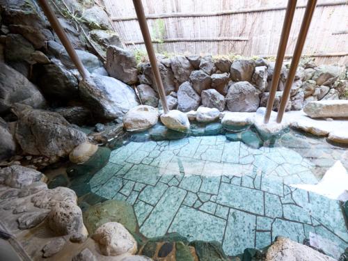 a small pool of water in a rock wall at Shuzenji Onsen Hotel Takitei in Izu