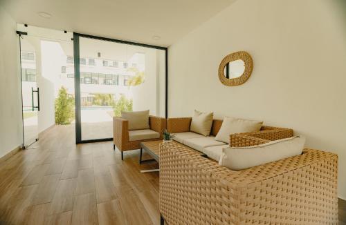 a living room with a couch and a mirror at Downtown Punta Cana Central Park 1 Bedroom B-300 in Punta Cana