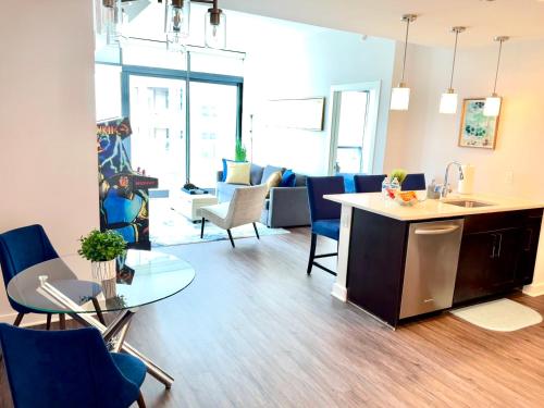 a kitchen and living room with a table and chairs at Skyline Retreat Penthouse, Top Floor, Year round Pool, City View! in Atlanta