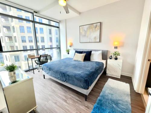 a bedroom with a bed and a large window at Skyline Retreat Penthouse, Top Floor, Year round Pool, City View! in Atlanta