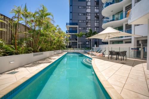 a swimming pool on the side of a building at Cilento Mooloolaba in Mooloolaba