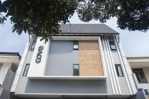 a white building with a window on the side of it at Cove Urooms Panglima Polim in Jakarta