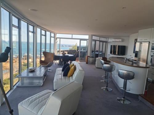 a living room with a white couch and some windows at Starship Enterprise in Wellington