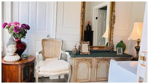a room with a mirror and a table with a chair at Cozy Place on Main Floor in Toronto